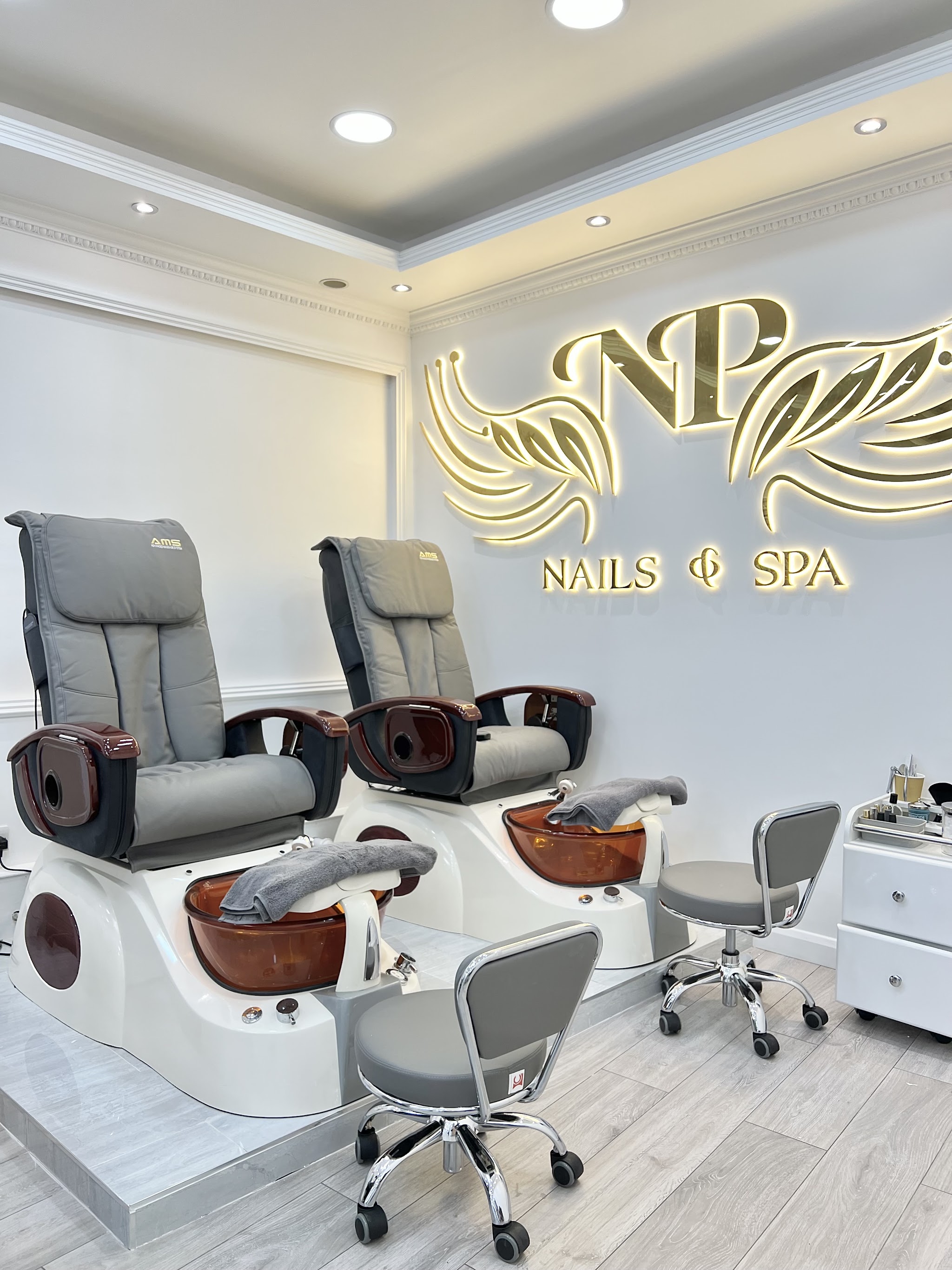 Our pedicure chairs under the gold NP Nails & Spa sign