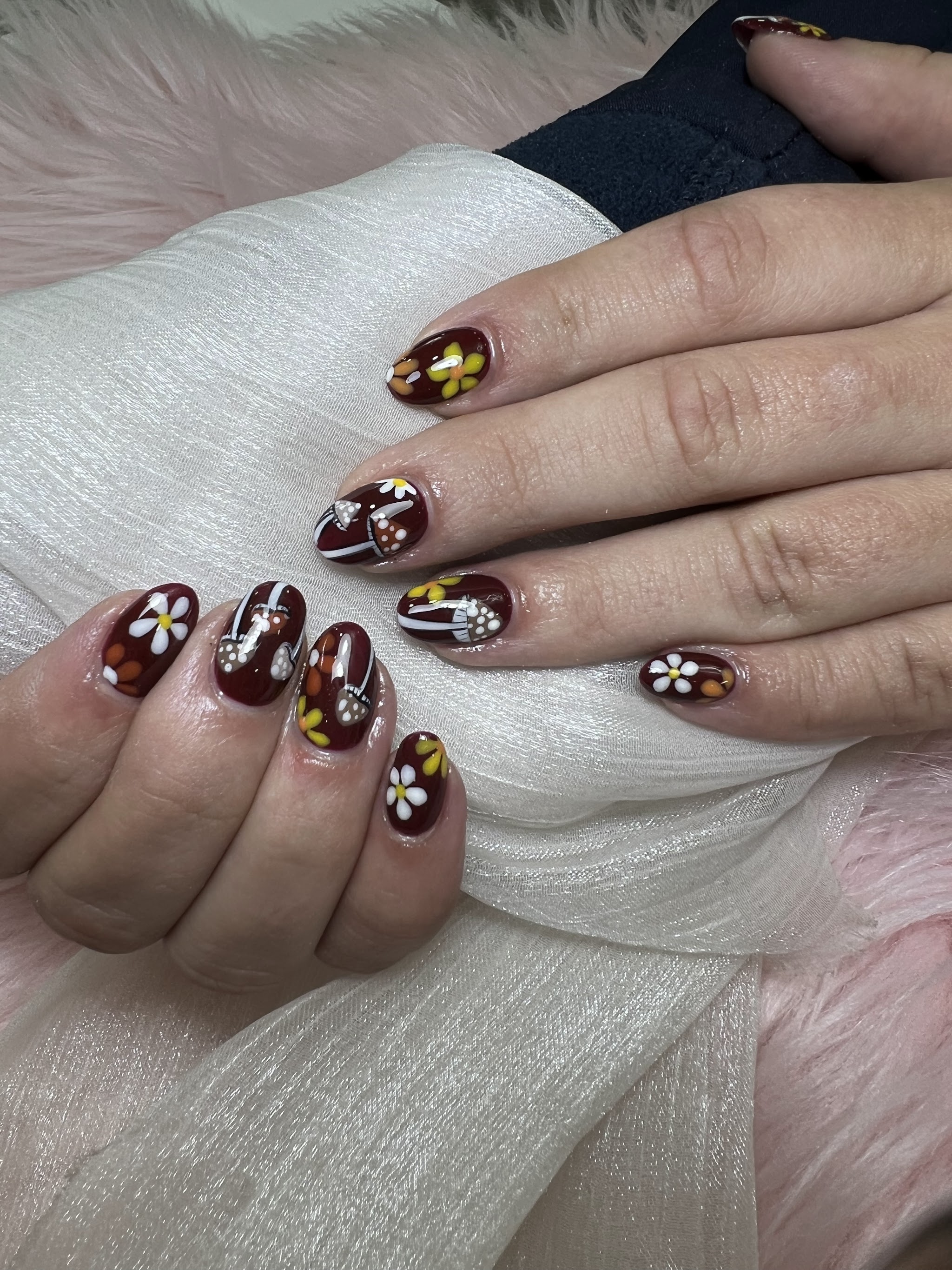 Burgundy nails with white and gold flower art