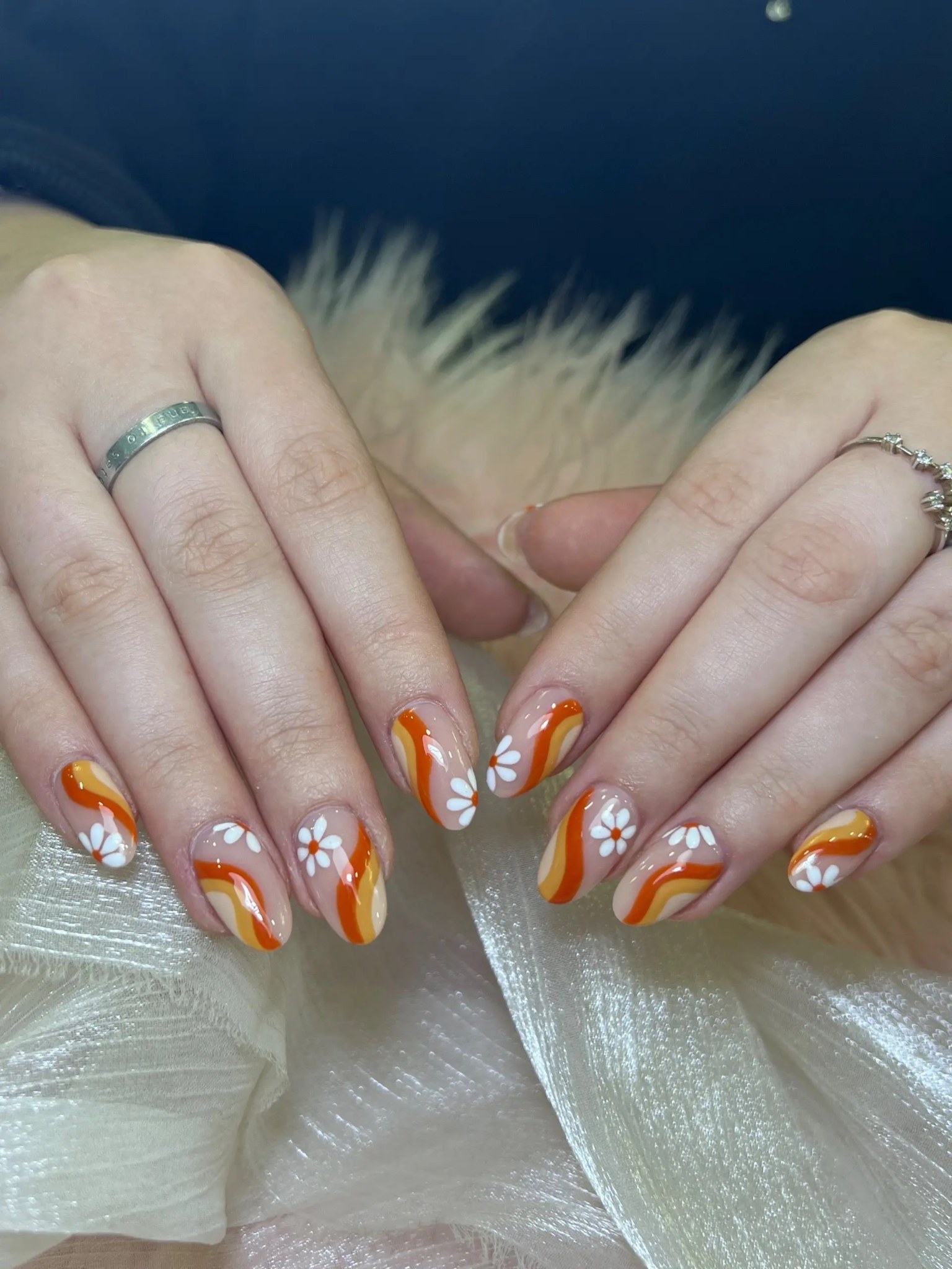 Orange and brown swirls with white flowers