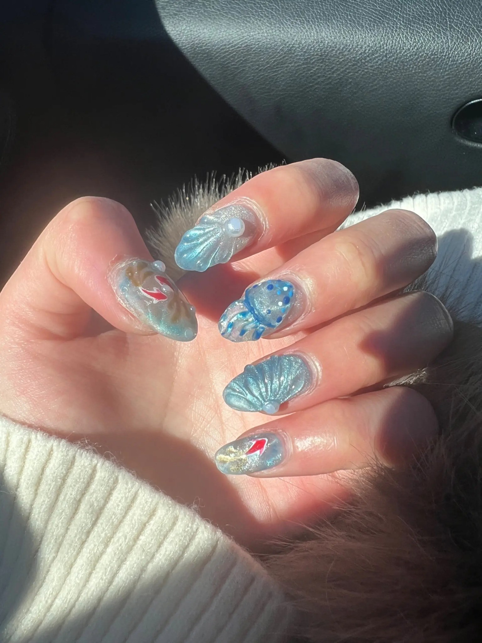 Translucent blue nails with shells and ocean art